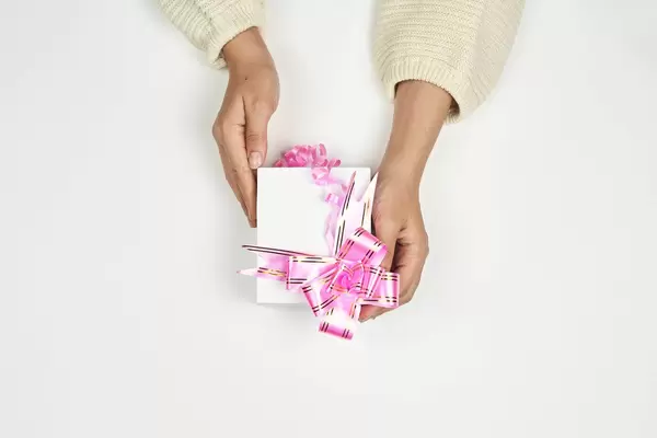 Hands of a woman holding a Christmas present