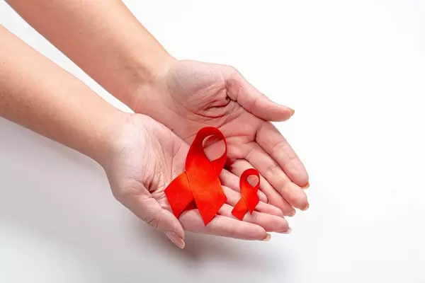 Hands of a woman holding two ribbons as a symbol of the fight and prevention of cancer (Flip 2019)