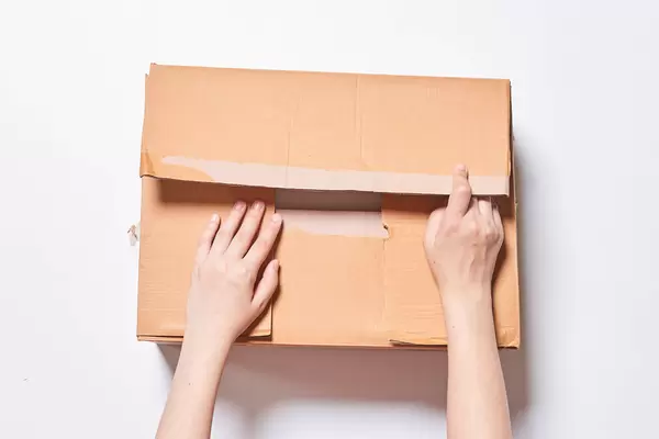 Hands of person open a big box