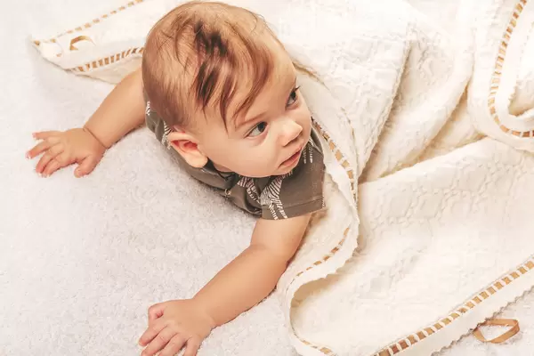 Handsome little boy just woke up in bed