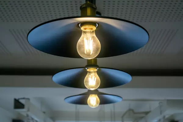 Hanging Design Lamp with Bright Light Bulbs in a modern Cafe Working Space