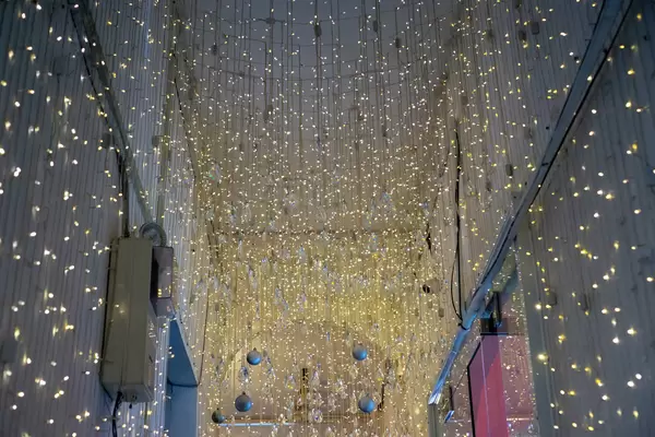 Hanging String Lights, Christmas Ornaments and Crystals as Decorations in a Cafe
