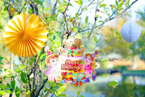 Happy Birthday card on a tree, outdoor party