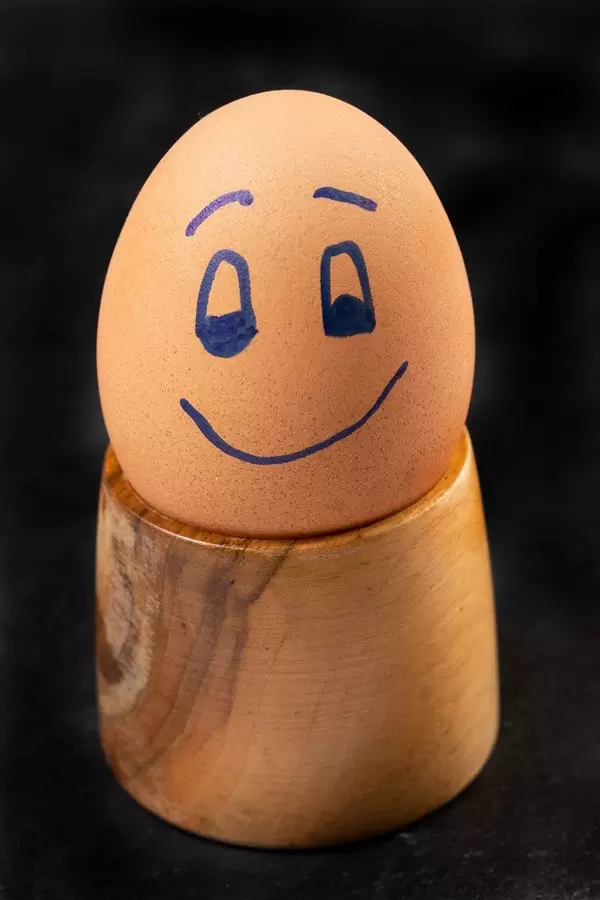 Happy Boiled Egg on the wooden holder