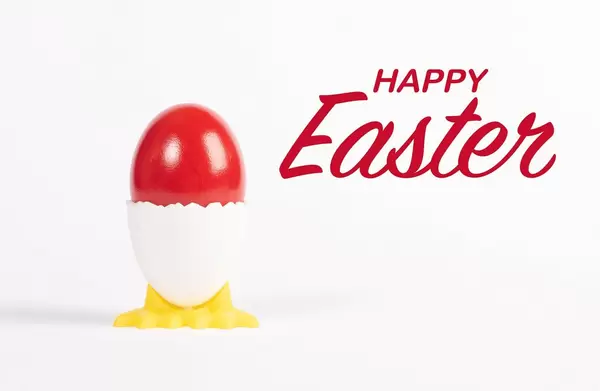 Happy Easter text with red painted Easter egg