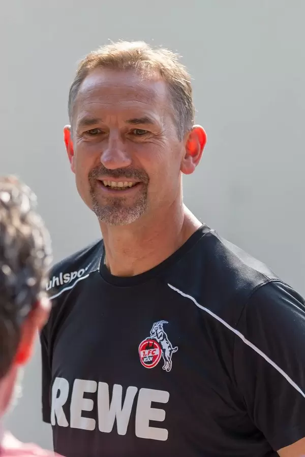 Happy soccer trainer Achim Beierlorzer smiling after team training