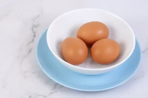 Hard Boiled Eggs in the bowl above grey marble table