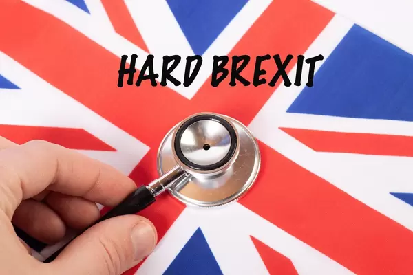 Hard Brexit text on a British flag with stethoscope