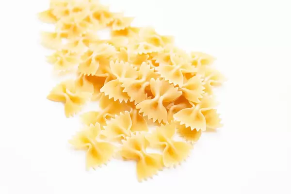 Harte Farfalle Nudeln mit Schärfentiefe freigestellt vor weißem Hintergrund