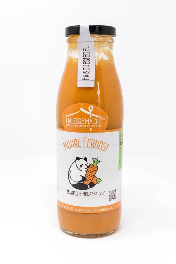 Hausgemachte asiatische Möhrensuppe aus Fernost in einer Glasflasche auf weißem Hintergrund