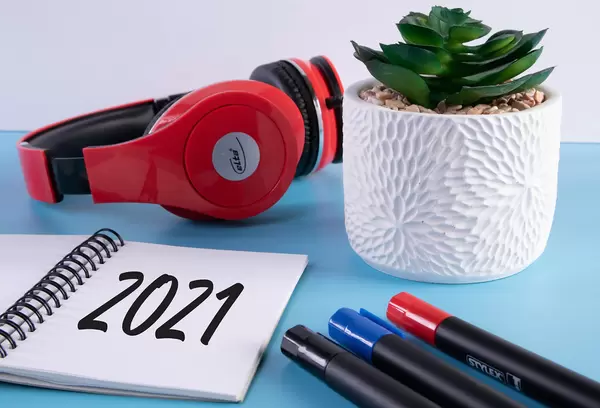 Headphones, flower and notebook with 2021 text