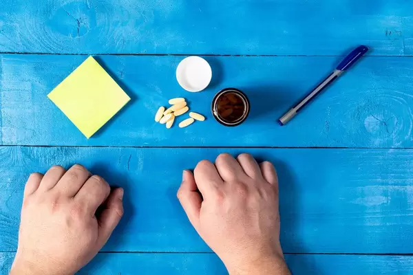 Health Concept with Pills on the table hands and copy space