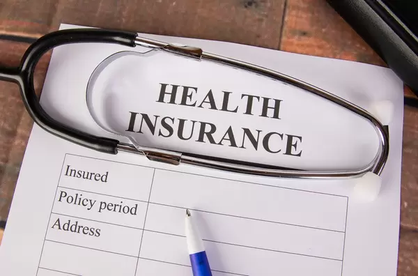 Health insurance form with stethoscope