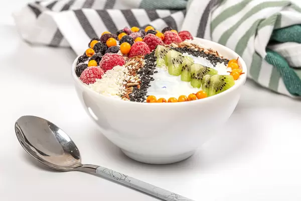 Healthy and delicious breakfast with oatmeal, yogurt, seeds and berries