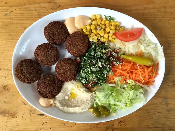 Healthy Arab lunch: Falafel with salad, corn, carrots and humus