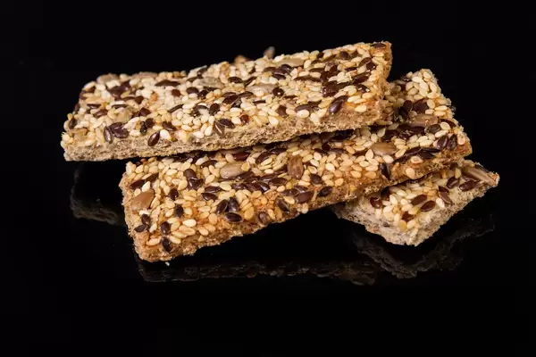 Healthy Bars with Sesame Sunflowers Seed and other cereals above black background (Flip 2019)