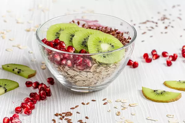 Healthy Breakfast background. Oatmeal with fruits and flax seeds