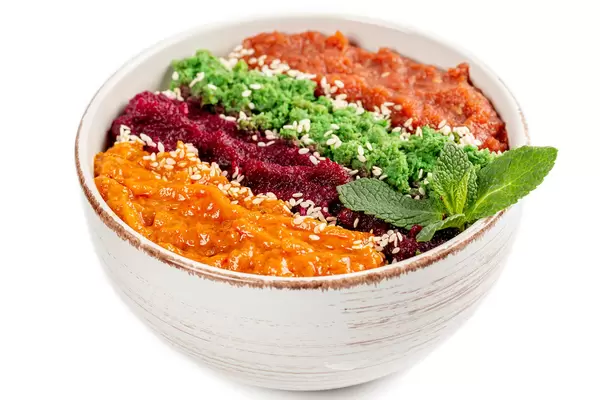 Healthy breakfast bowl, oatmeal and multi-colored fruit purees