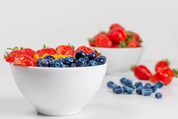 Healthy breakfast concept - oatmeal with fresh berries on a white background