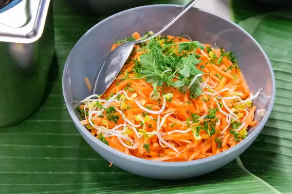 Healthy carrot salad with sprouts and green herbs, in a bowl at AXA Barcamp OMWest19 in Cologne, Germany