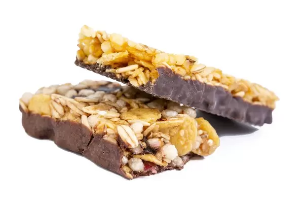 Healthy Cereal Bar with Cranberries and Milk cream above white background