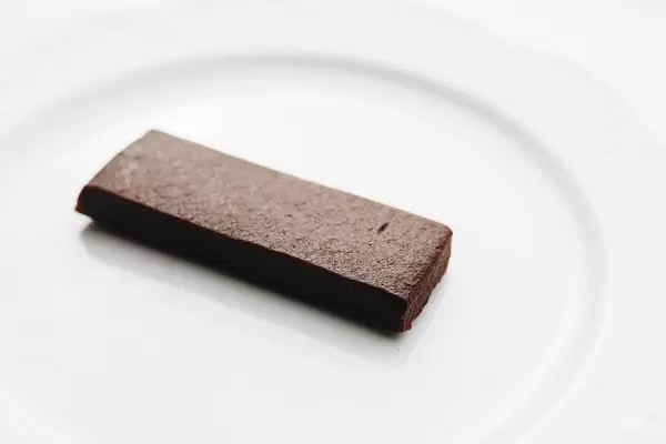 Healthy chocolate bar dessert on white background.