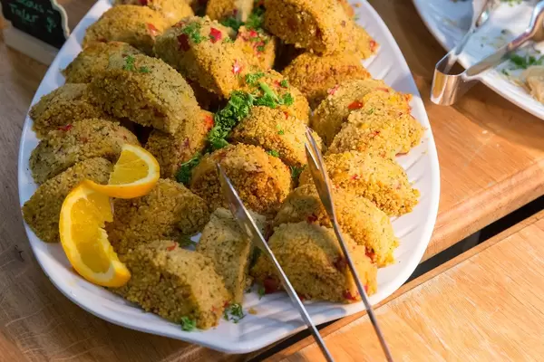 Healthy couscous slices with vegetables and herbs at a food buffet