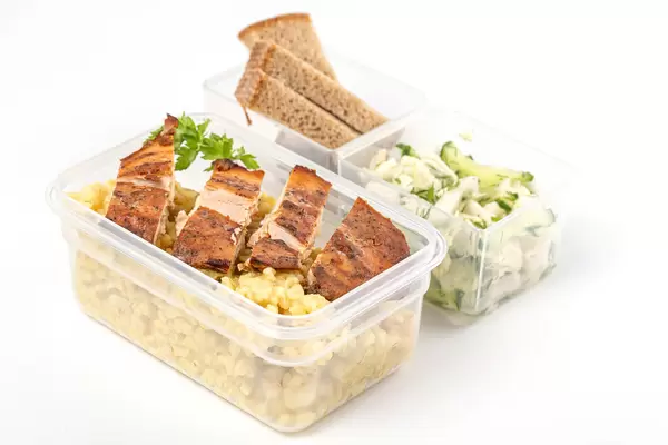 Healthy diet lunch boxes with vegetables salad, chicken fillet and bulgur porridge