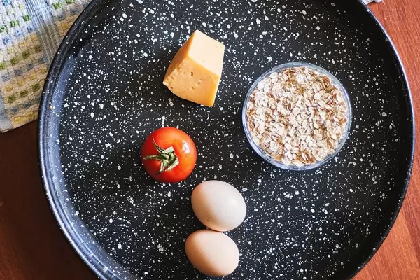 Healthy food - a cheese, oatmeal, tomato and eggs.jpg