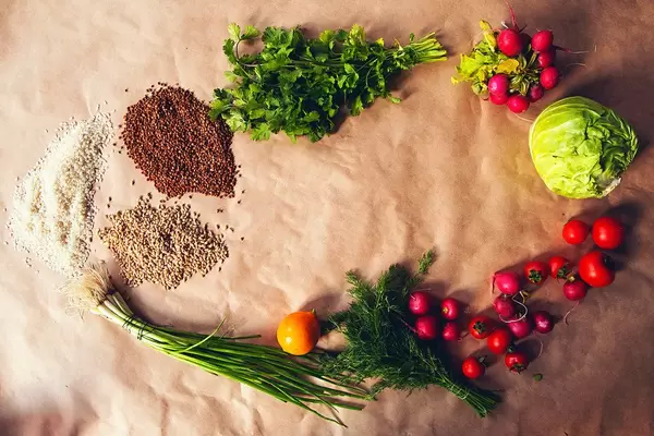 Healthy food background. Assortment of fresh vegetables and cereals on paper background (Flip 2019)