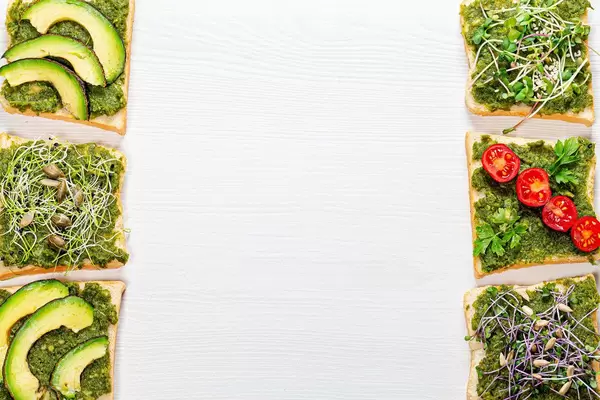 Healthy food background with free space. Sandwiches with fresh micro-greens, seeds and vegetables (Flip 2019)