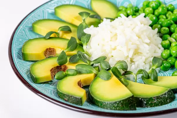 Healthy food concept- rice with vegetables and sunflower microgreen on a blue plate (Flip 2020)