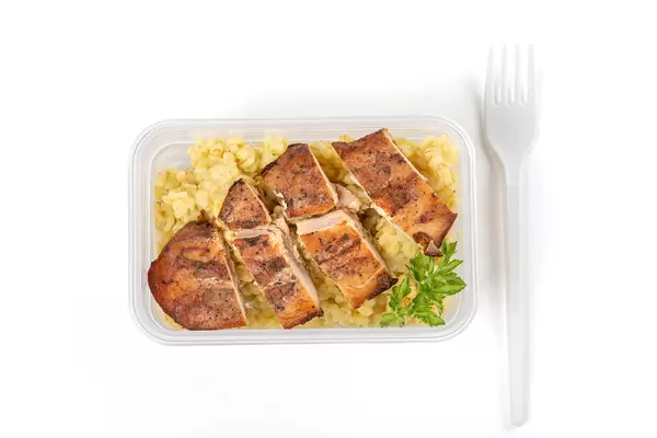 Healthy food container - boiled bulgur with baked chicken fillet, top view