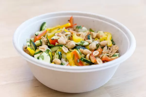 healthy food from vegetables like peppers and cucumber, peanuts and herbs