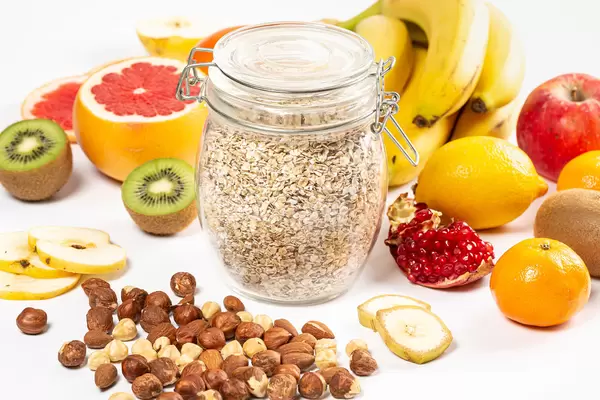 Healthy lifestyle concept, nuts, different fruits and oatmeal