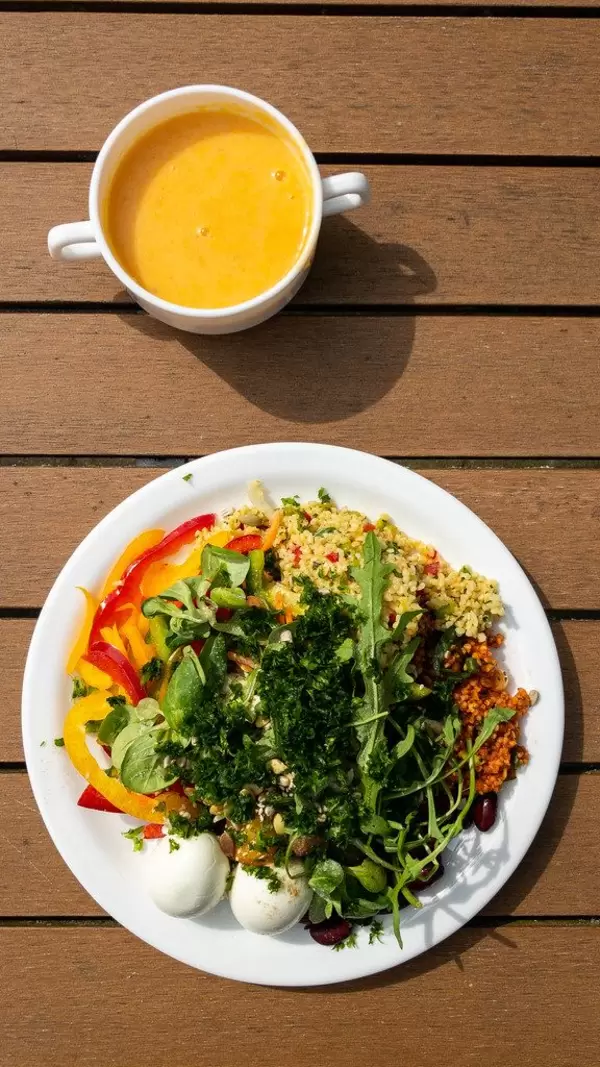 Healthy lunch at the cafeteria of the German Sports University Cologne, with eggs, peppers, lamb's lettuce and yolk drink