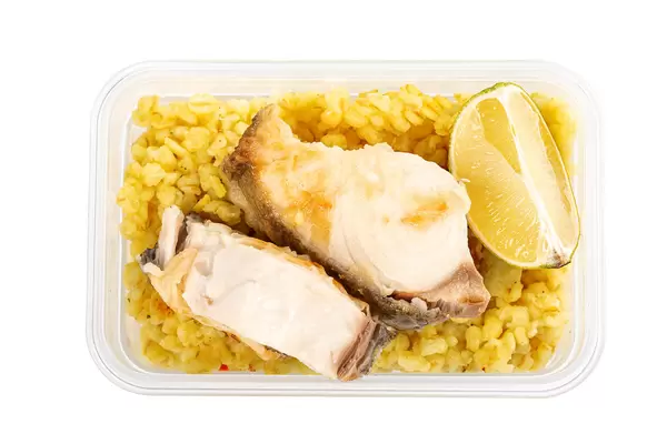 Healthy lunch box with fish, porridge and lime slices