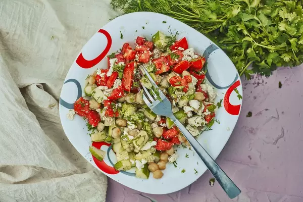 Healthy lunch of Greek salad on a plate with fork