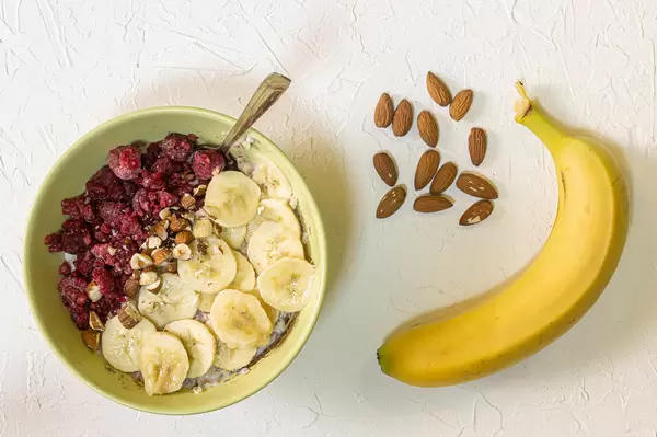 Healthy meal with cereals banana and raspberries