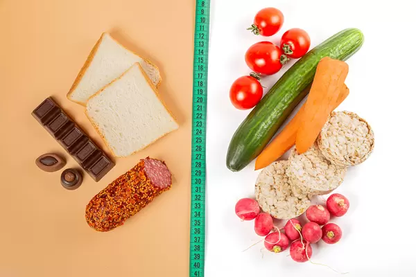 Healthy nutrition concept, vegetables vs sweets and unhealthy food