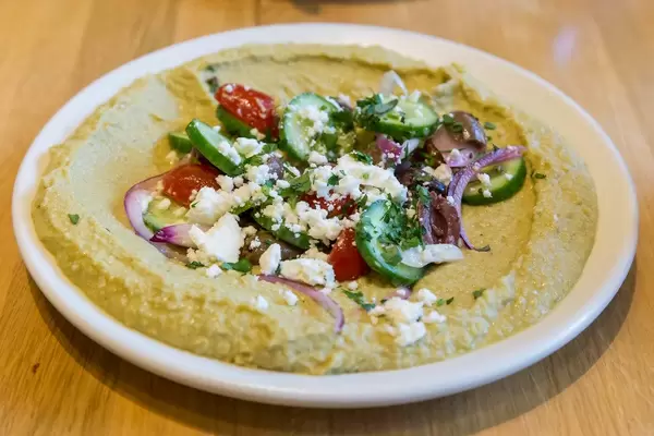 Healthy seasonal food at True Food Kitchen in Chicago: Herb Hummus with cucumber, organic tomato, onion, olive, feta, lemon & oregano vinaigrette & house-made pita
