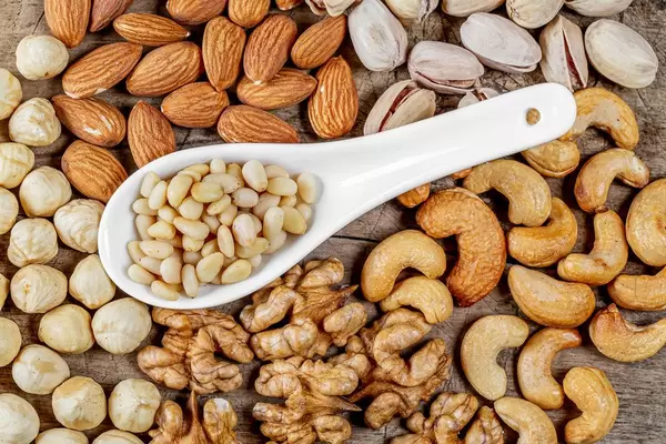 Healthy snack concept-nuts on a wooden background, top view (Flip 2020)