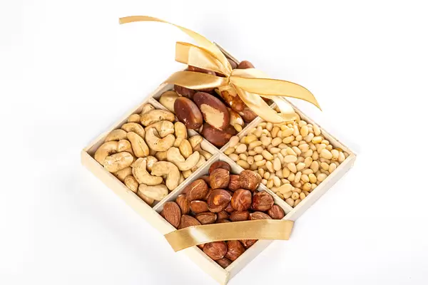 Healthy snack concept, set of nuts in a box with ribbon and bow