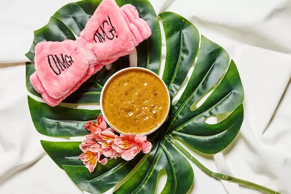 Healthy summer skin cream on the palm leaf