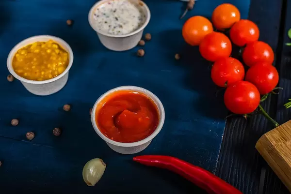 Healthy vegetarian cooking ingredients for tasty pumpkin dishes recipes in bowls : tomato sauces, spinach, sliced onion, pumpkin. (Flip 2019)