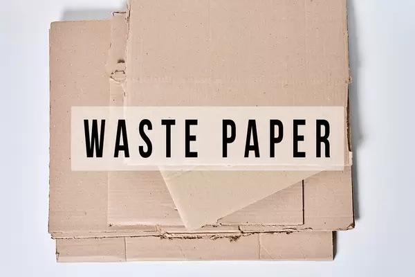 Heap of cardboard for recycling with text - Waste paper
