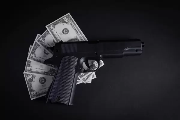 Heap of money and handgun