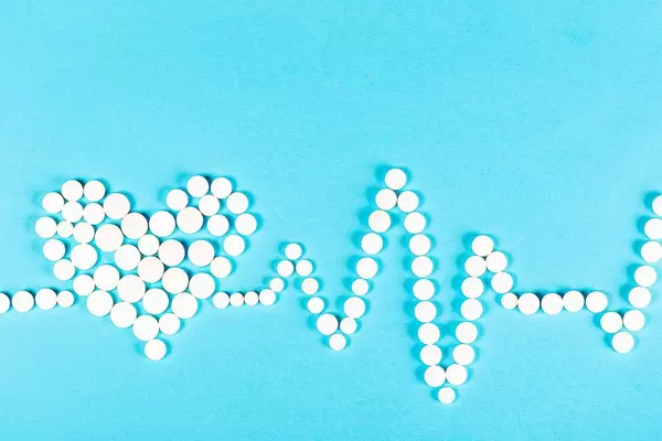 Heart and cardiogram made from pills, heart disease and treatment concept