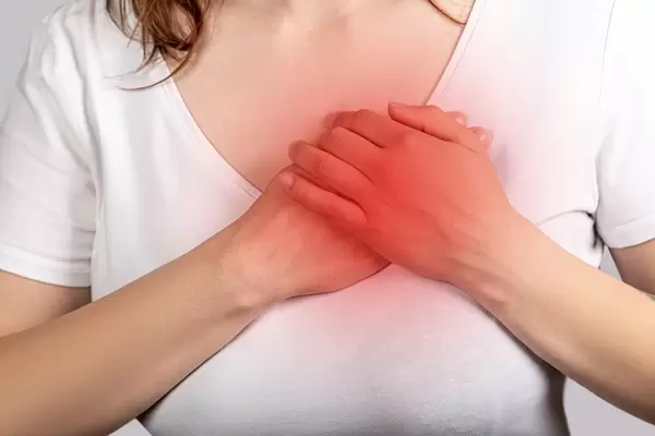 Heart attack concept, woman suffering from chest pain