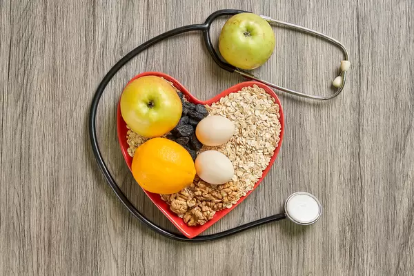 Heart-healthy foods with stethoscope on wood
